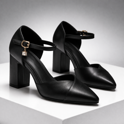 Black pointed-toe block heel pumps with ankle strap and gold buckle charm for women