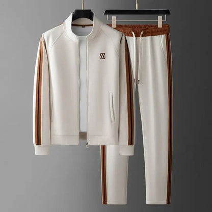 White men's zip-up tracksuit set with brown leather side stripes, stand collar jacket and drawstring jogger pants.