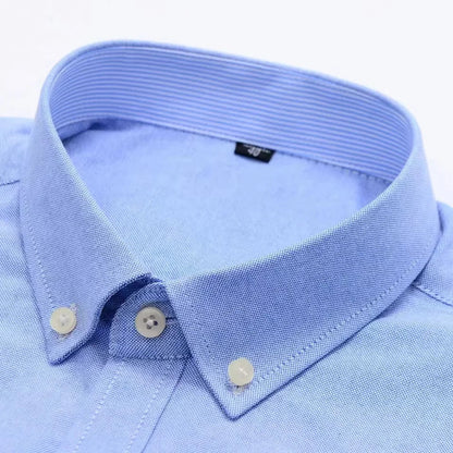 Light blue men's cotton dress shirt collar with white buttons and textured fabric detail