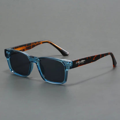 Rectangular sunglasses with transparent blue frames, dark lenses, and tortoiseshell temples with silver hardware detail.