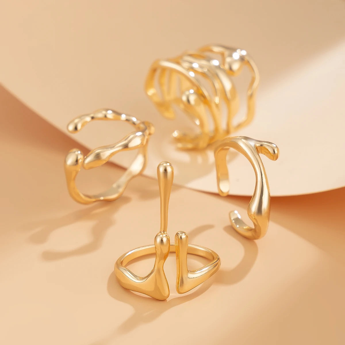 Gold adjustable open rings set for women featuring abstract geometric designs and twisted band styles in polished finish