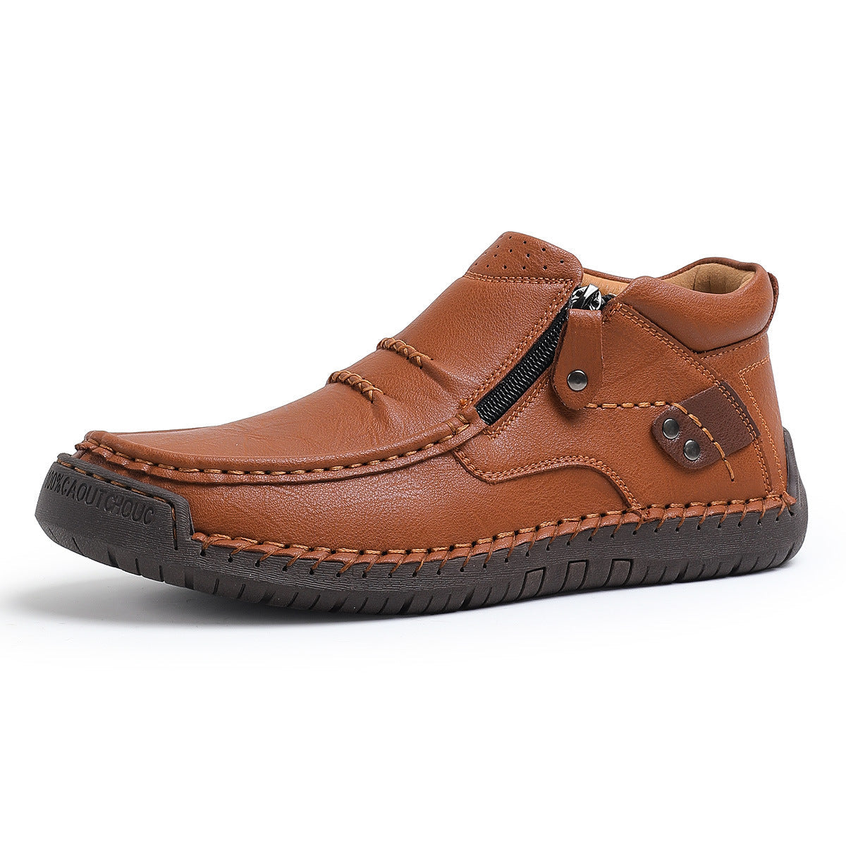 Men's tan leather slip-on ankle boots with side zipper, hand-stitched detailing, metal rivets, and dark rubber sole.