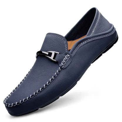 Navy blue leather men's slip-on loafer with silver metal buckle accent and white contrast stitching detail