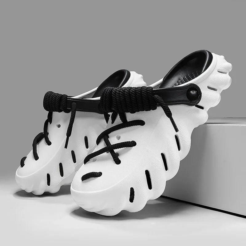 White and black cushioned foam clog shoes with lace-up design, ventilation holes, and adjustable heel strap for men