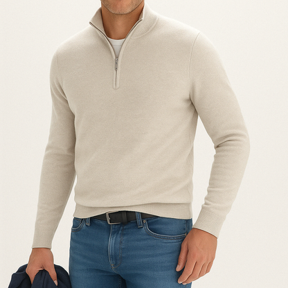 Men's beige cashmere blend quarter-zip sweater with ribbed cuffs and hem, styled with blue jeans and white t-shirt underneath.