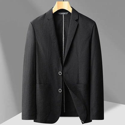 Black men's two-button blazer on wooden hanger with notch lapel, patch pockets, and textured fabric detail.