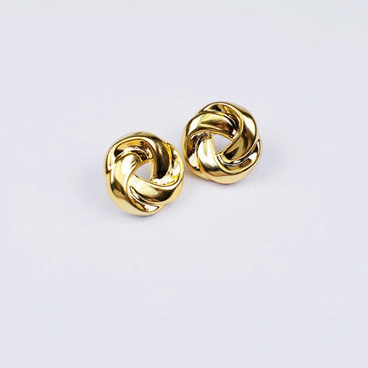 Gold twisted knot stud earrings with interlocking swirl design and snap closure, shown as a pair on white background