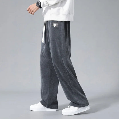 Men's wide-leg gray corduroy drawstring sweatpants with R. logo patch, paired with white sneakers and sweatshirt