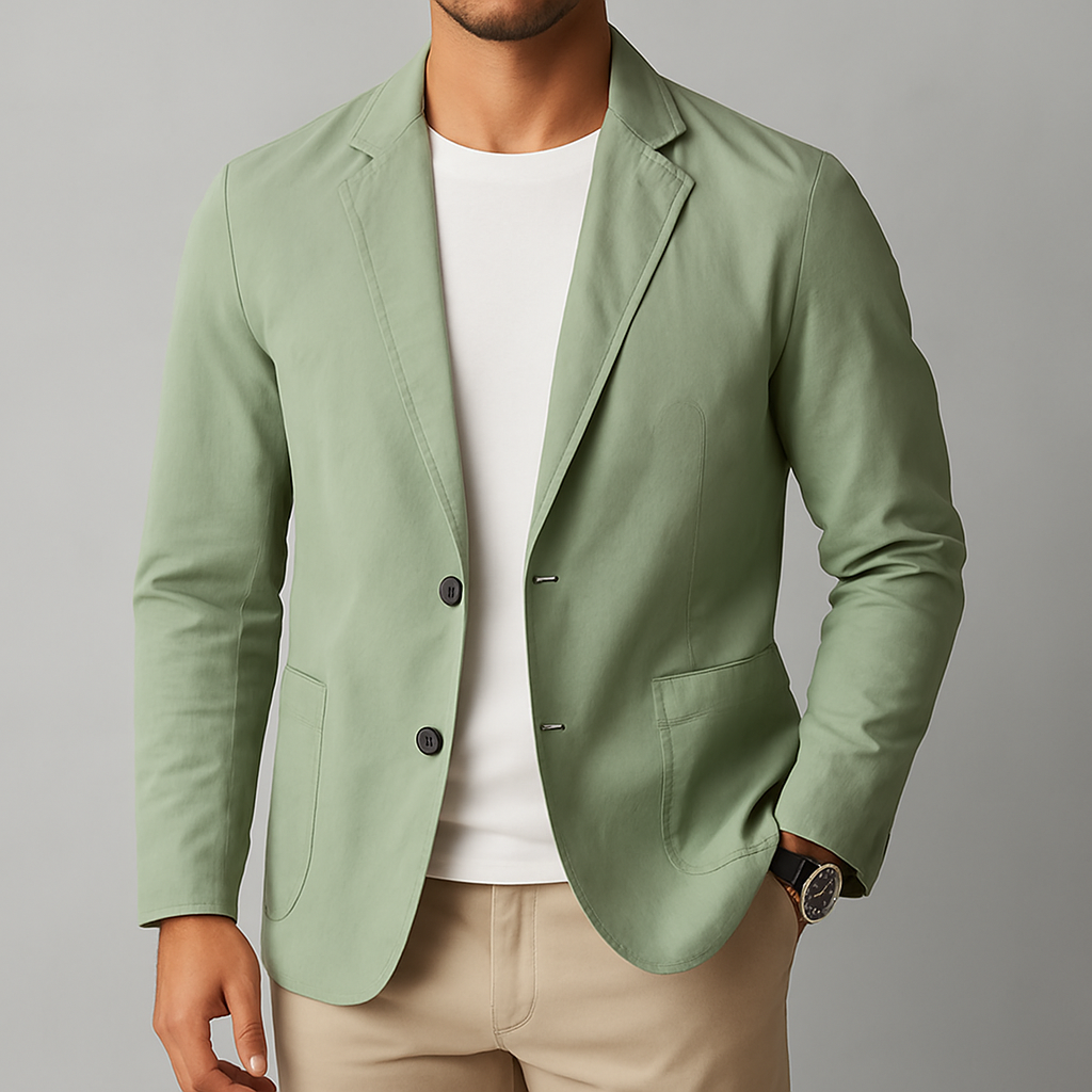 Man wearing a sage green nylon two-button blazer jacket over a white tee with beige pants and a watch.