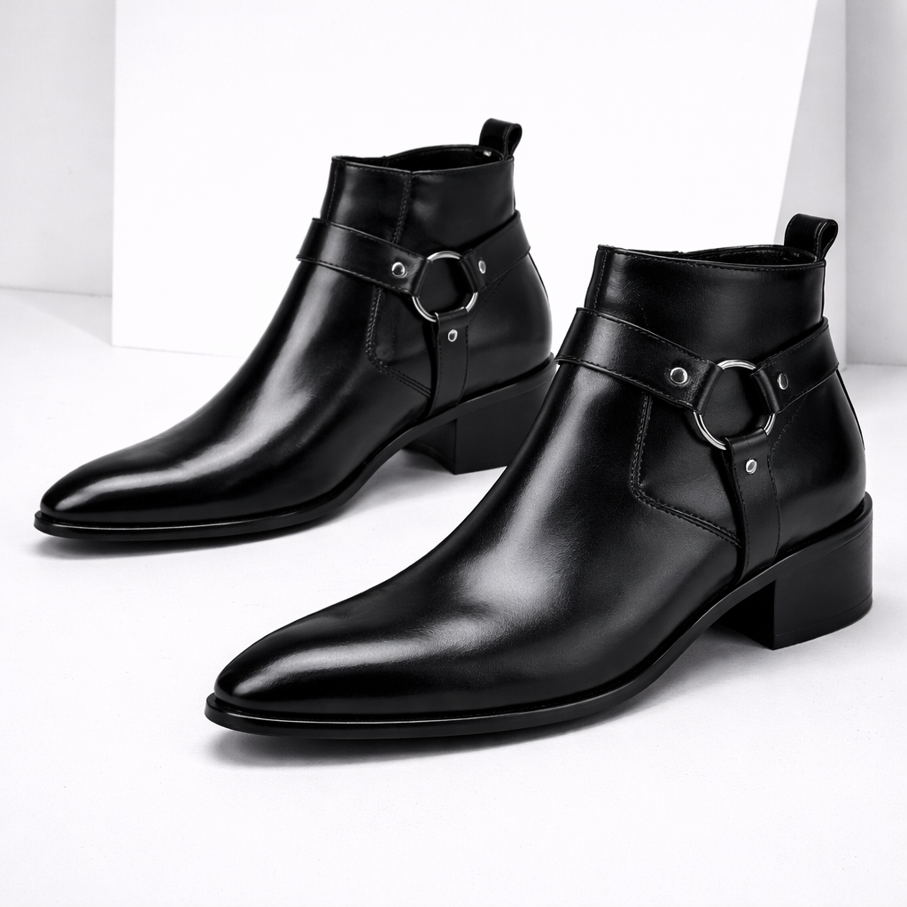 Black leather men's ankle boots with silver harness ring detail, pointed toe, block heel, and side zipper closure.
