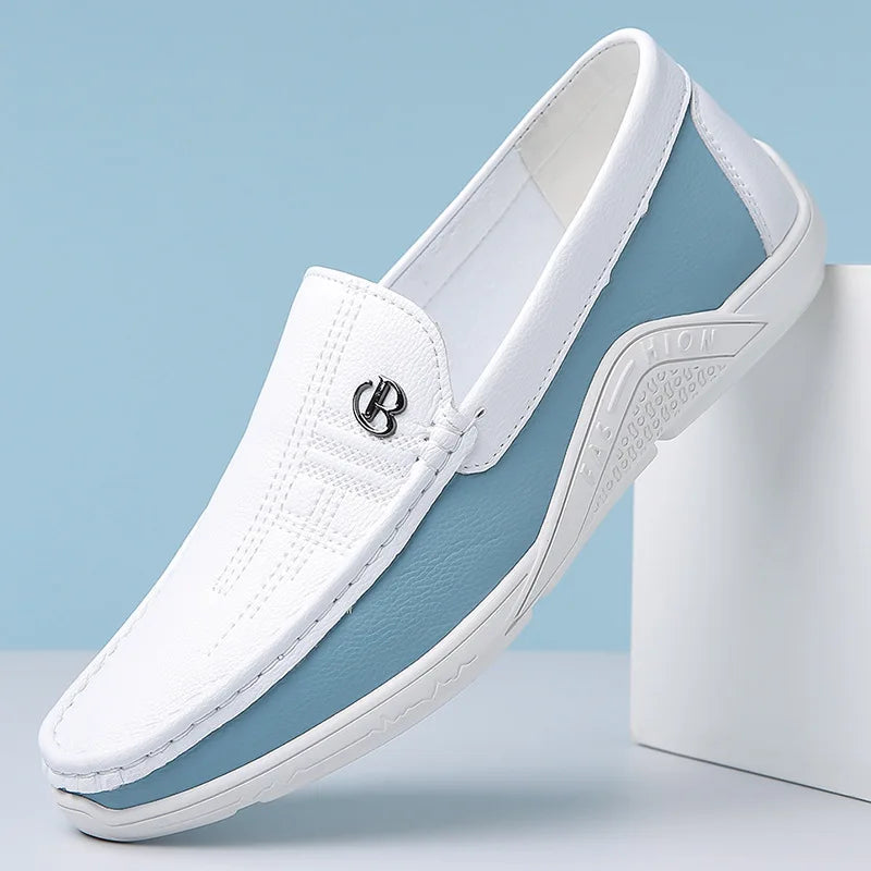 White and blue men's leather slip-on loafers with metal logo detail and textured sole on light blue background