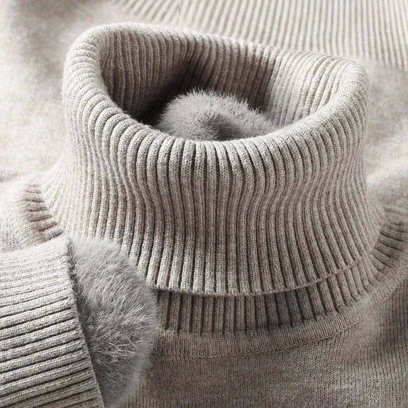Men's merino wool turtleneck sweater in beige with ribbed knit texture and soft fleece-lined collar detail.