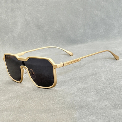 Gold frame square aviator sunglasses for men with black gradient lenses and metal temples on gray background