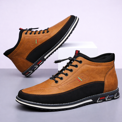 Torven men's tan leather mid-top sneakers with black laces, black sole accents, and colorful embroidered logo detail.