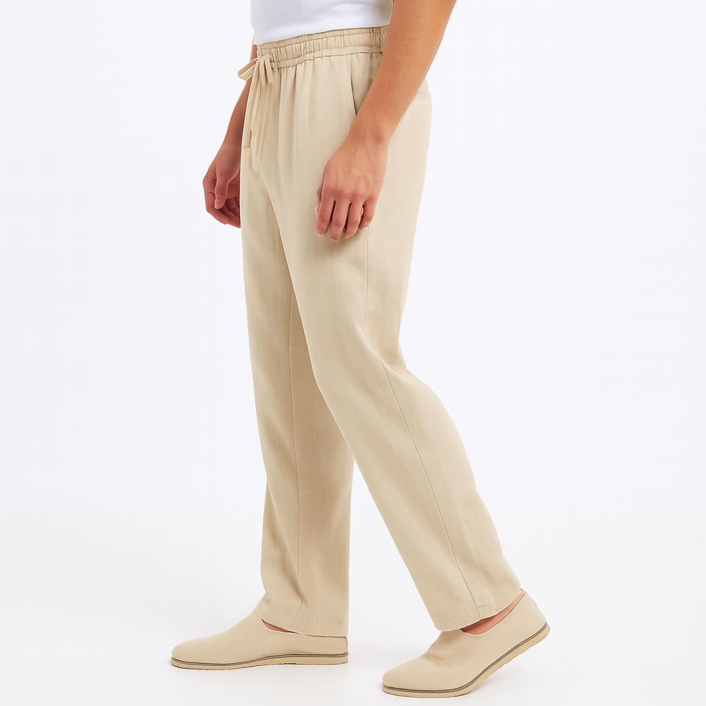 Men's beige cotton drawstring pants with elastic waist and matching slip-on shoes on white background