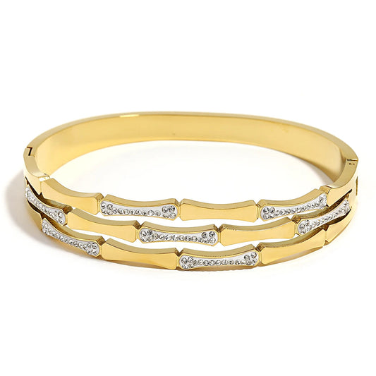 Gold tone bangle bracelet with geometric bamboo design and crystal stone accents for women