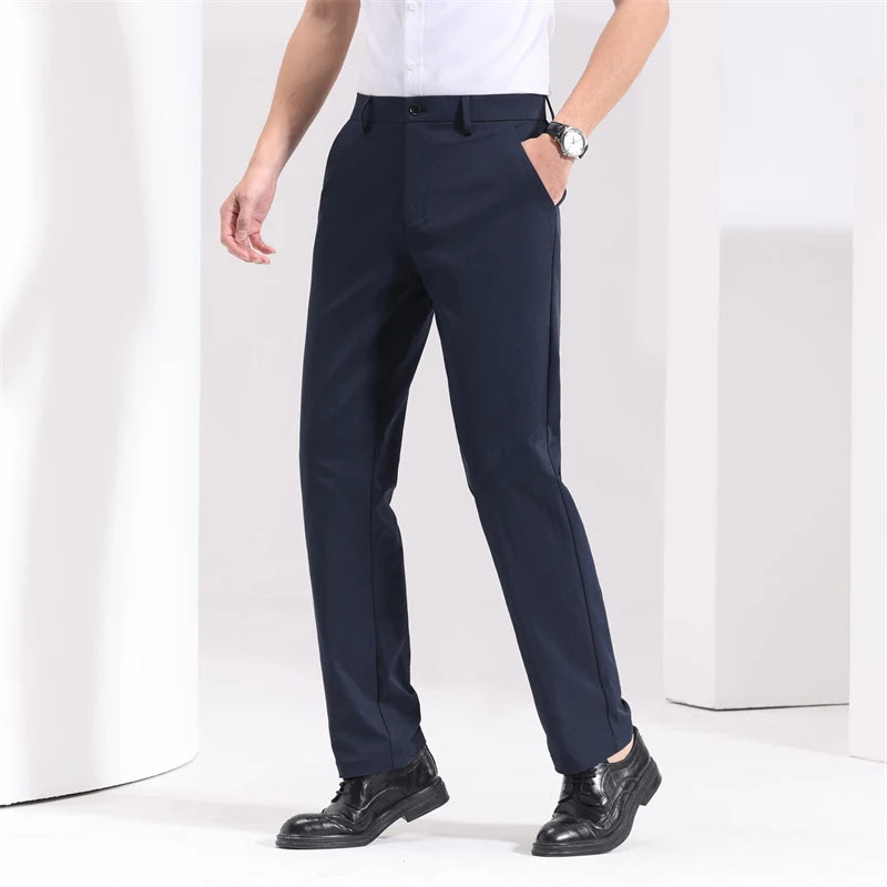 Navy blue slim-fit men's dress trousers with side pockets, worn with white shirt and black leather shoes.