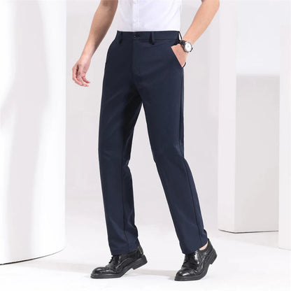 Navy blue slim-fit men's dress trousers with side pockets, worn with white shirt and black leather shoes.