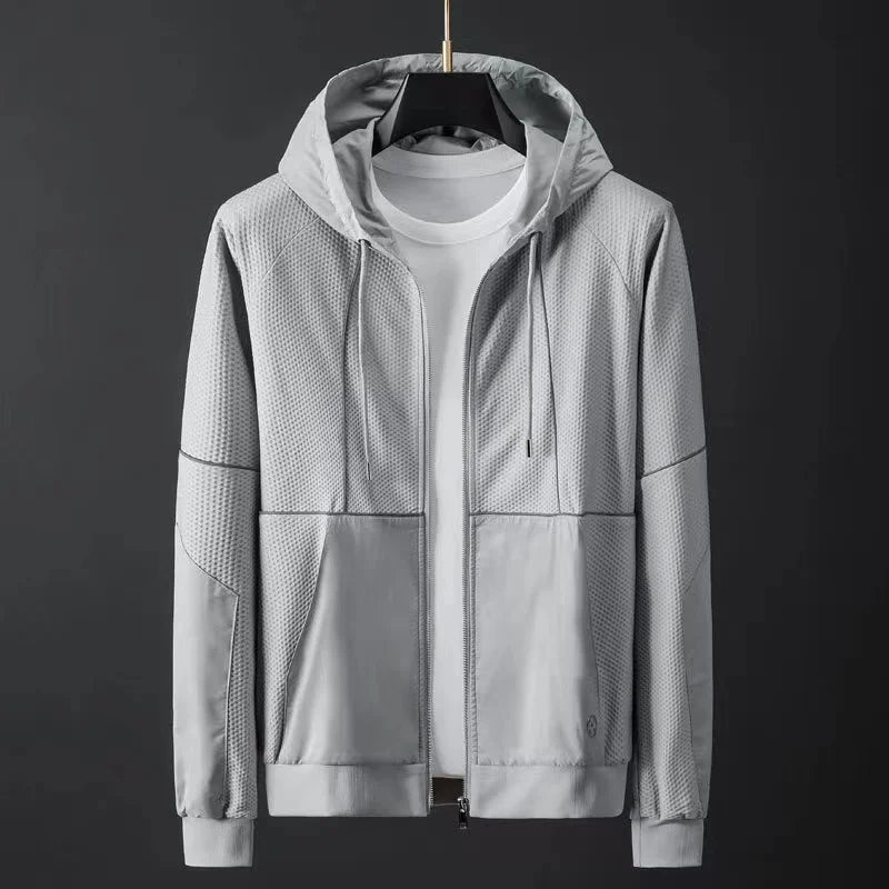 Light gray men's hooded zip-up jacket with textured mesh panels, drawstring hood, front pockets, and ribbed cuffs
