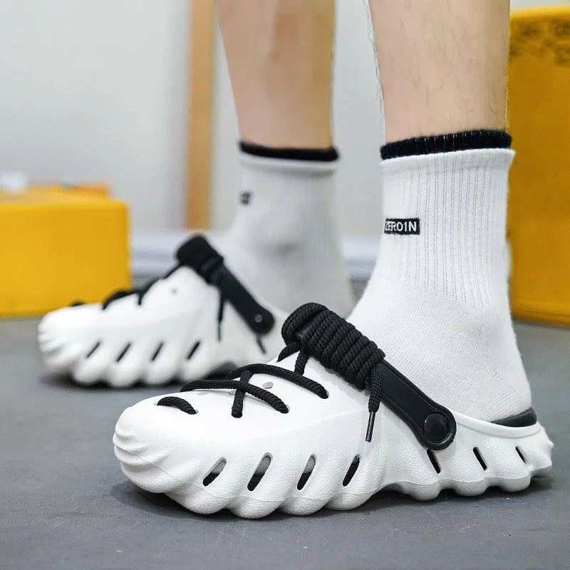 White cushioned foam clog shoes with black laces and perforated design, men's slip-on style footwear with ribbed sole