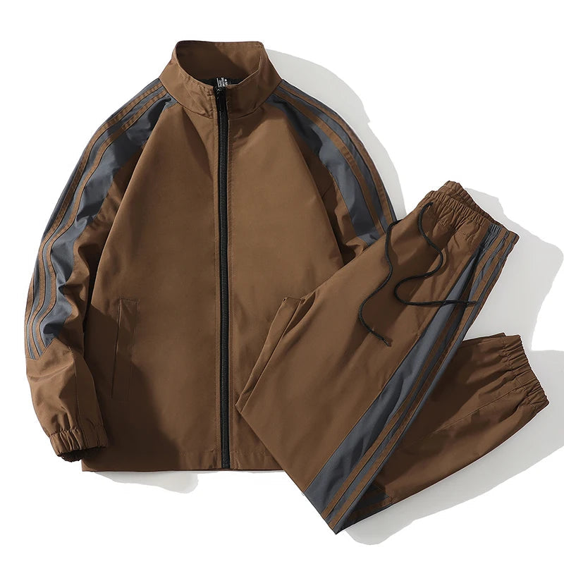 Brown men's full-zip tracksuit set with gray side stripes, elastic waist jogger pants, and stand collar jacket