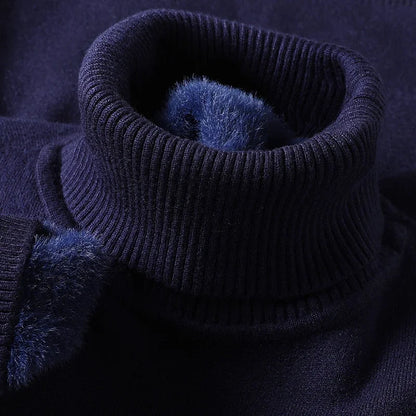 Navy blue men's merino wool turtleneck sweater with ribbed collar and soft fleece interior lining detail.