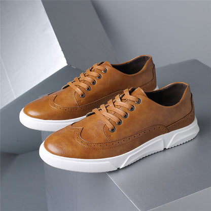 Men's brown leather lace-up sneakers with white rubber sole and brogue detailing on casual athletic shoes