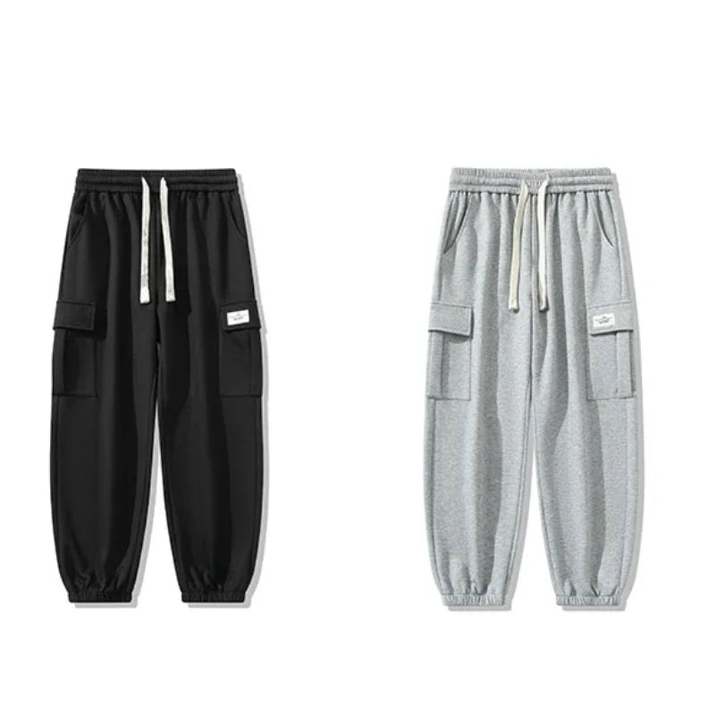 Two men's cargo jogger pants with drawstring waist and side pockets, shown in black and light gray colorways.