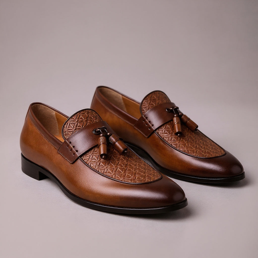 Brown leather tassel loafers with woven textured vamp detail and slip-on design for men's dress shoes