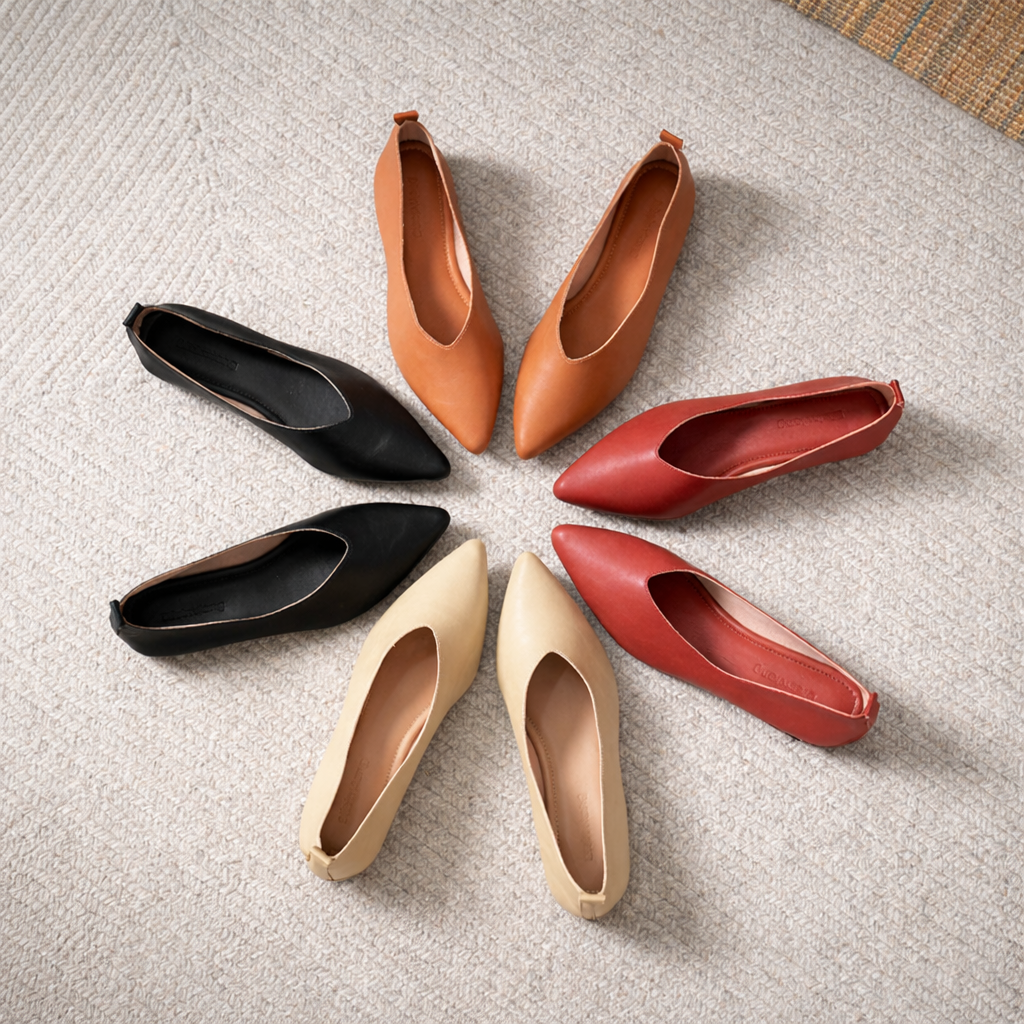 Four pairs of women's leather pointed-toe pumps arranged in a circle: tan, red, black, and beige colorways on carpet.