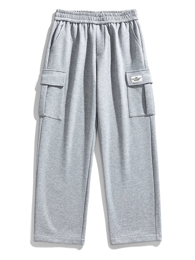 Gray wide-leg men's cargo sweatpants with elastic waistband, side cargo pockets, and small label patch detail