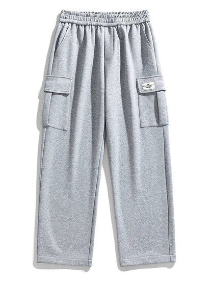 Gray wide-leg men's cargo sweatpants with elastic waistband, side cargo pockets, and small label patch detail