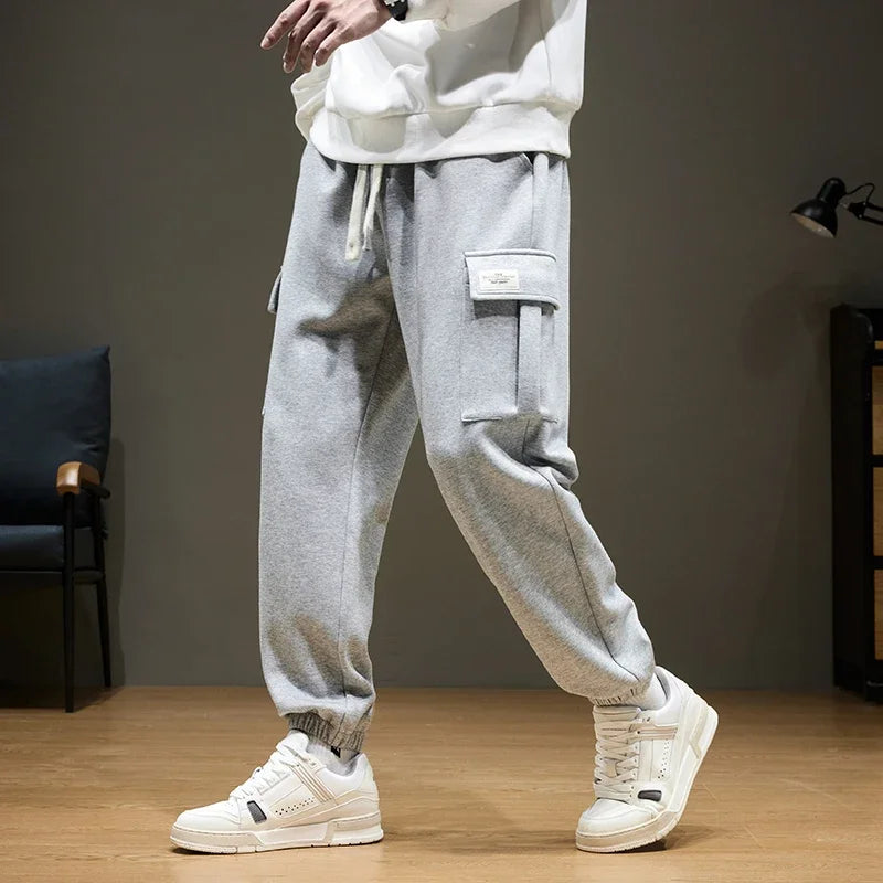 Men's gray cargo joggers with drawstring waist and utility pocket, relaxed fit sweatpants for casual wear
