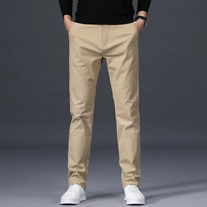 Men's slim-fit beige cotton dress pants with straight leg, business casual chinos on gray background