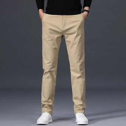 Men's slim-fit beige cotton dress pants with straight leg, business casual chinos on gray background