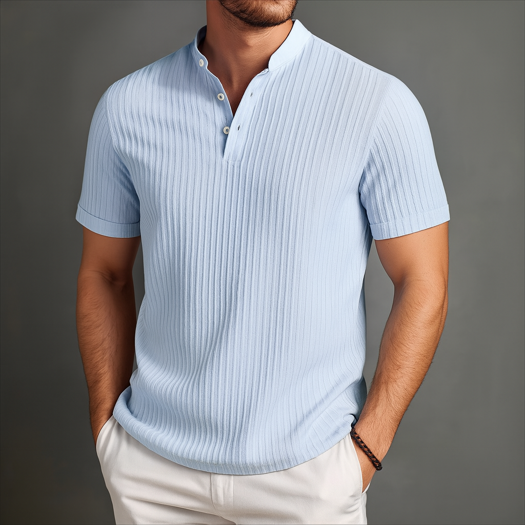 Men's light blue ribbed linen band collar short sleeve popover shirt with button placket, paired with white pants.