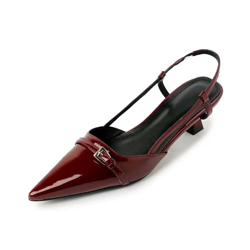 Burgundy patent leather pointed-toe slingback pumps with small block heel and silver buckle detail
