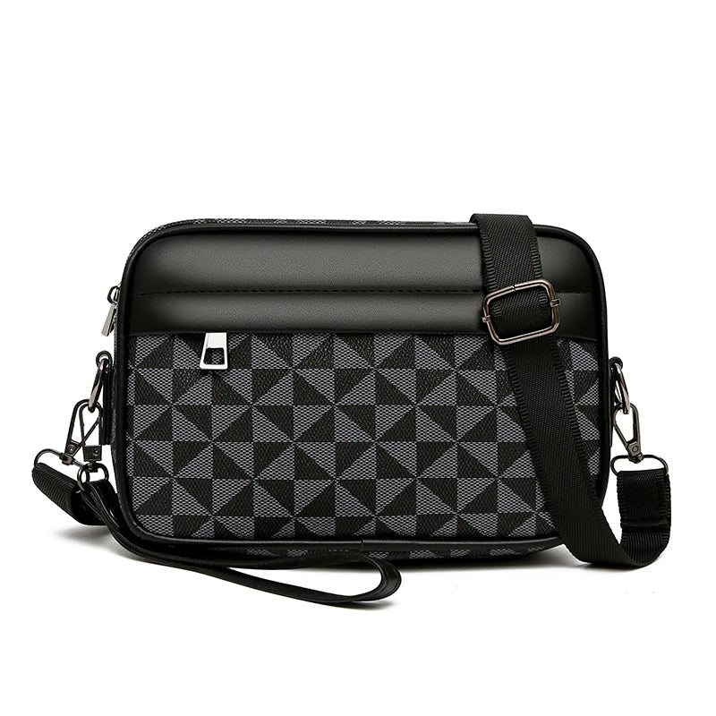 Black and gray geometric checkered crossbody bag with adjustable strap, zip closure, and wrist loop handle