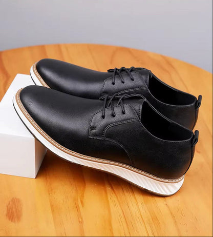 Black Torino Leather Orthopedic Sneakers with white chunky sole and lace-up design displayed on wooden surface