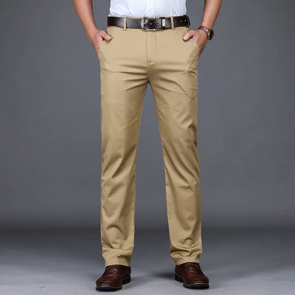 Men's slim fit khaki cotton blend dress pants with brown leather belt and dark brown oxford shoes
