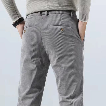 Gray corduroy slim fit chino pants for men back view showing vertical ribbed texture and pockets