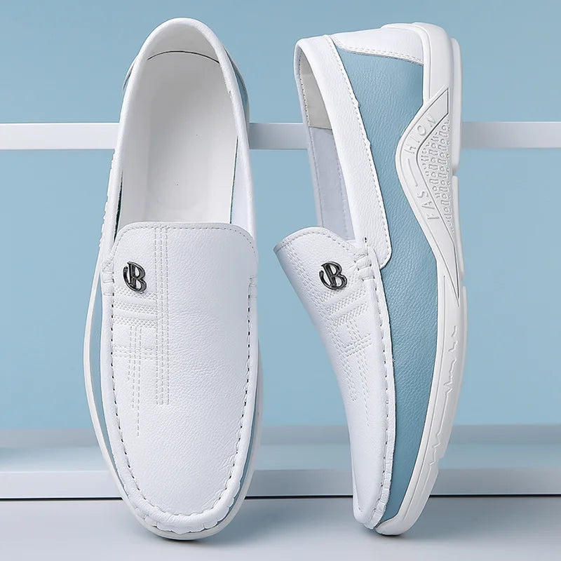 White leather slip-on loafers for men with blue sole, decorative stitching, and silver B logo emblem