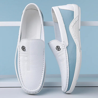 White leather slip-on loafers for men with blue sole, decorative stitching, and silver B logo emblem
