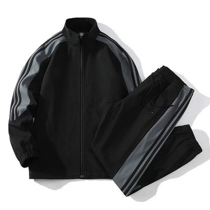 Black men's full-zip tracksuit set with gray stripe detail on sleeves and pant legs, stand collar jacket and jogger pants