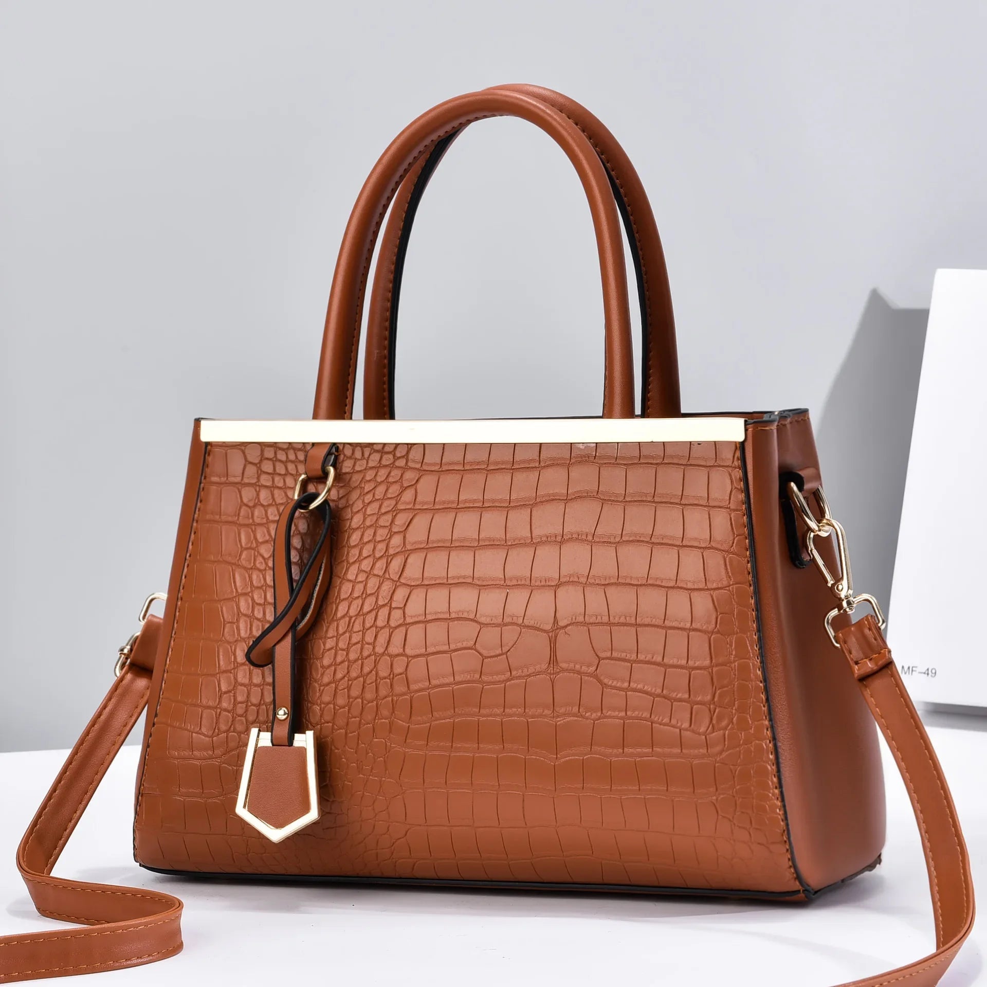 Women's brown croc-embossed leather structured handbag with top handles and adjustable shoulder strap