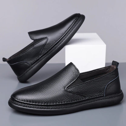 Black men's leather slip-on loafers with pebbled texture, elastic side gussets, and flexible rubber sole, shown in pair.