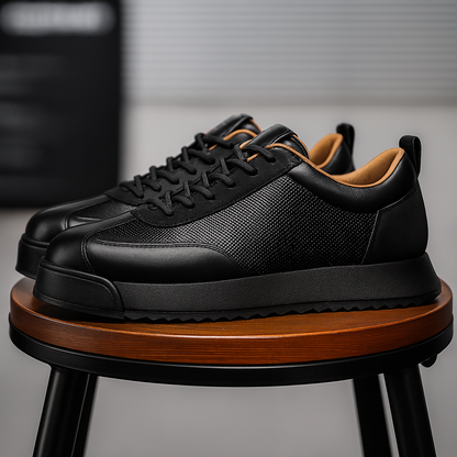 Black leather lace-up orthopedic sneakers with textured panel and tan interior, displayed on wooden stool