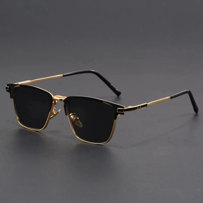 Men's metal frame polarized sunglasses with gold trim, black lenses, and black temple tips on gray background.