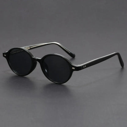 Black round frame Verano UV400 sunglasses for men with dark lenses and acetate temples on gray background