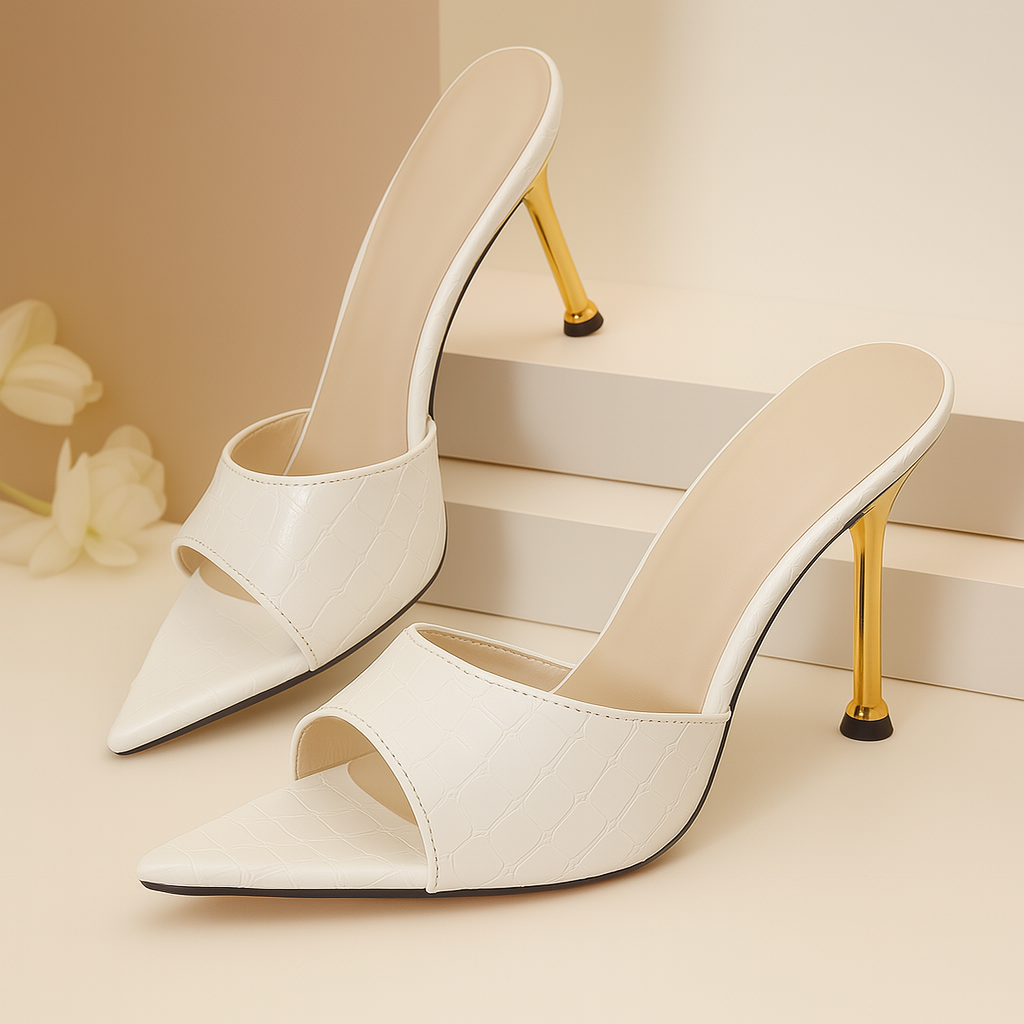 White croc-embossed open-toe stiletto mule heels with gold metallic heel and pointed toe detail